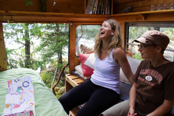 Maggie and Carmen in her bus looking at Lineage Book