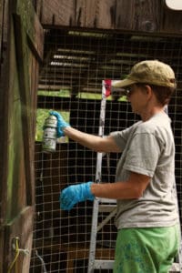 Profile of Carmen painting the interior doors